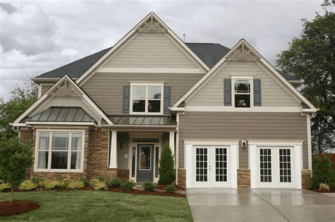 taupe siding house with metal roofs|taupe siding accent colors.